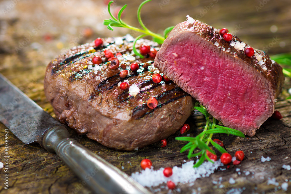 Wall mural juicy fillet steak with fresh herbs