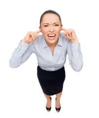 businesswoman screaming with closed ears