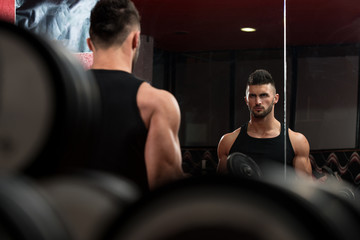 Young Men Doing Exercise For Biceps