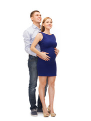 happy young family expecting child looking up