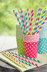 Paper cups and striped straws