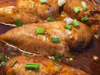 Chicken Breasts Cooking in a Cast Iron Pan with Green Onions
