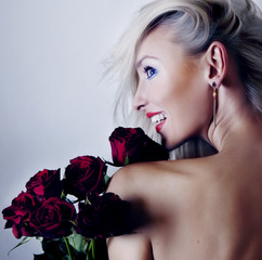 Cheerful blonde woman with flowers