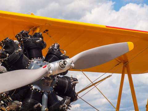 Vintage Yellow Propeller Aircraft Parked at an Airport