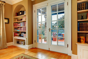 Classic entrance hall with wooden glass doors and built-in wall