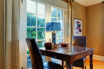 Elegant wooden table set with leather chairs