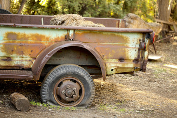 Fototapeta na wymiar Flat Tire on Rusty Flatbed Truck; Retro Tech