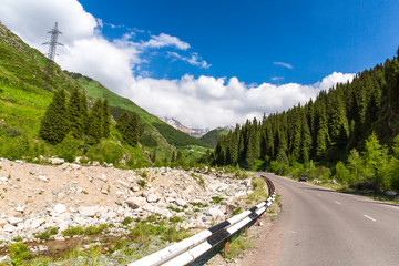 Road on Big Almaty Lake, nature green mountains and blue sky