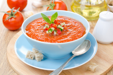 cold tomato soup gazpacho with basil and croutons in a bowl