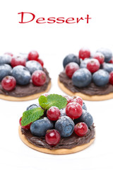 mini cakes with chocolate cream and berries