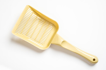 A white plastic pooper scooper to clean cat's or dog's excrements