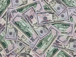 A Pile of Fifty Dollar Bills as a Money Background