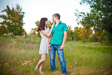 Fototapeta premium loving couple looking at each other in the forest