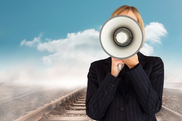 Composite image of closeup of a businesswoman with a megaphone