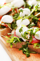 Tomato, mozzarella and arugula sandwich