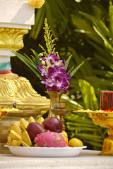 Buddhist altar with gifts and orchids