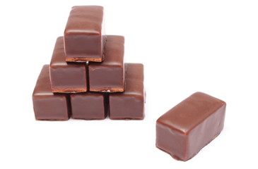 Stack of chocolate sweets on white background