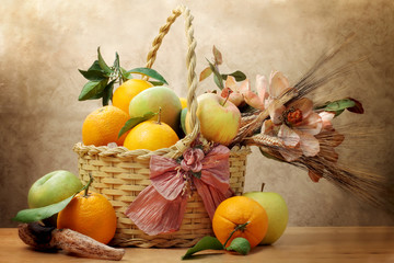 oranges and green apple inside wicker basket