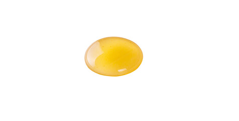 A drop of natural honey over white background