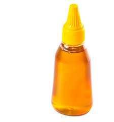 A bottle of natural honey over white background