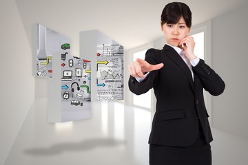 Composite image of businesswoman pointing