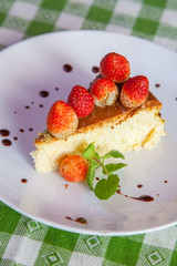Cheese cake and ice-cream on plate with fruit topping.