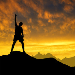 Silhouette of tourist on the top in the sunset.