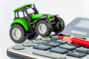 tractor, red pen and calculator