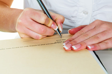 hand with fountain pen signing contract