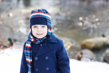 Adorable toddler boy on beautiful winter day