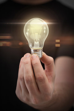 Close Up Of Man Hand Holding Light Bulb