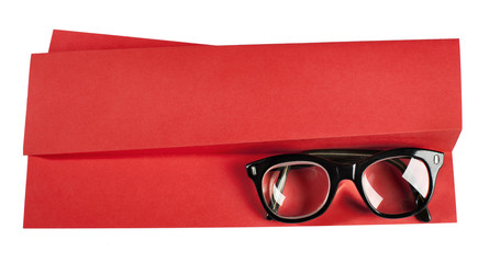 Vintage eyeglasses with black frame on red creative support