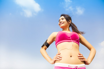 Running woman jogging outdoors listening to music