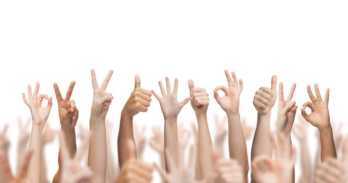 human hands showing thumbs up, ok and peace signs