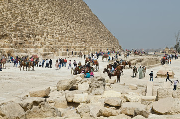 Tourists near famous Egyptian pyramids