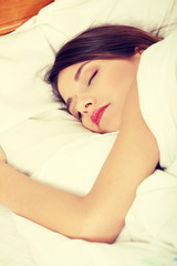 Obraz na płótnie Canvas Beautiful young woman sleeping