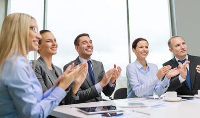 business team with laptop clapping hands