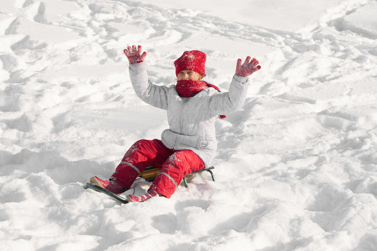 girl  sled through the snow