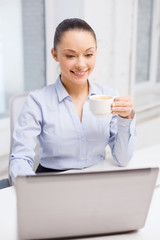 smiling businesswoman or student with laptop