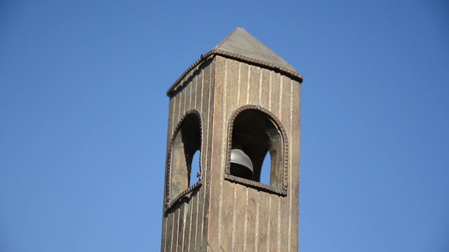 belfry imitation with bell move on background of blue sky