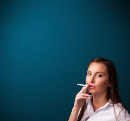 Obraz premium Beautiful woman smoking cigarette vith copy space