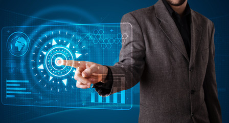 Businessman pressing high tech type of modern buttons