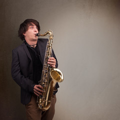 Obraz na płótnie Canvas Young musician playing on saxophone