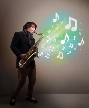 Young musician playing on saxophone while musical notes explodin