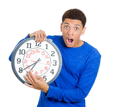 Stressed man holding clock, running out of time