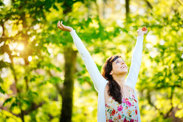 Blissful woman enjoying freedom on spring