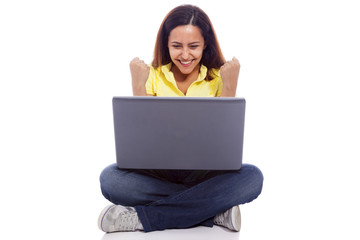 Naklejka premium Happy woman with a laptop and arms up, isolated over white backg