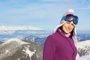 Smiling girl in winter mountains