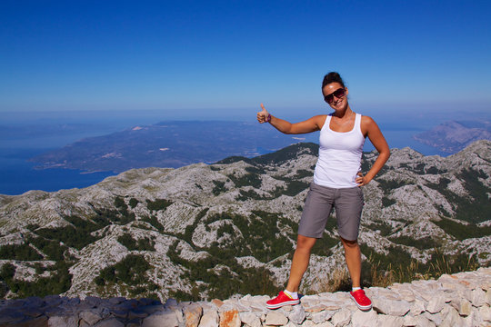 Smiling girl on hilltop