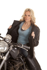Fototapeta na wymiar Woman open leather jacket sit on motorcycle
